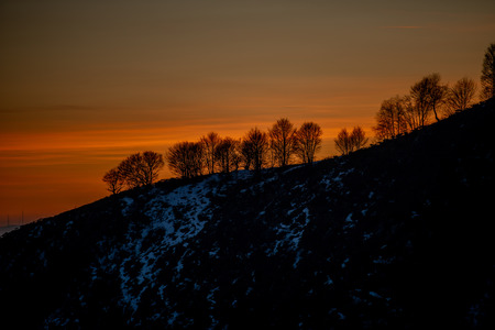 sunset behind the mountain resegoneの写真素材