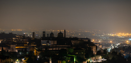 Skyline of the old city of Bergamo at nightの写真素材