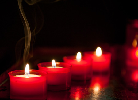 votive candles lit in the churchの写真素材