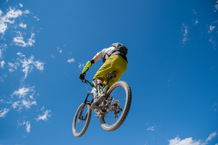 Livigno italy July 27th 2015:boy who finishes the descent by bike with a jumpの写真素材