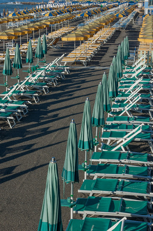 umbrellas ordered in the beach waiting for the swimmersのeditorial素材