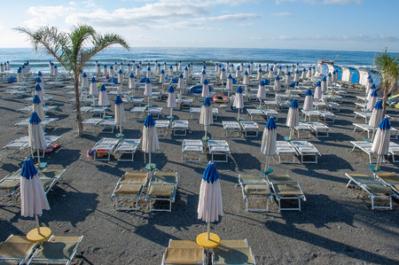umbrellas ordered in the beach waiting for the swimmersの写真素材