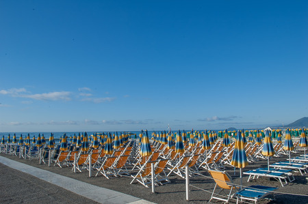 umbrellas ordered in the beach waiting for the swimmersの写真素材