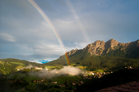 mountain in the clouds after the storm with rainbowの写真素材