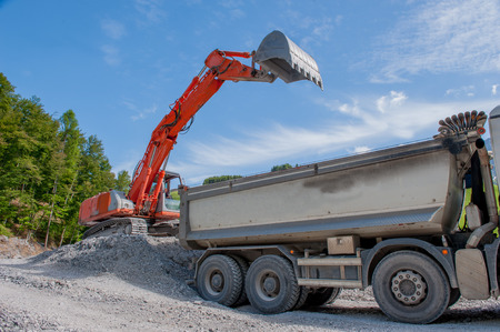 load of gravel with bulldozer in construction siteの写真素材
