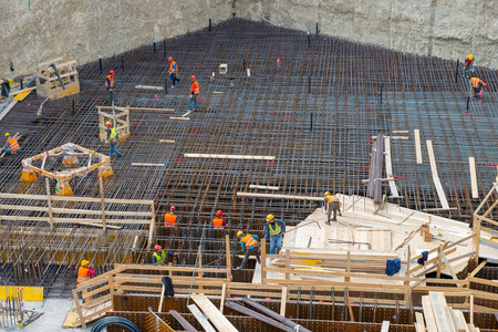 MILAN, ITALY 10 APRIL, 2019: workers at work for the construction of the reinforced concrete base in the new business district in the island districtのeditorial素材