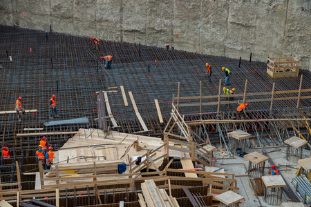 MILAN, ITALY 10 APRIL, 2019: workers at work for the construction of the reinforced concrete base in the new business district in the island districtのeditorial素材