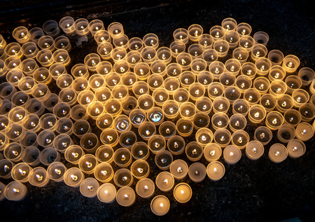 votive candles lit in the churchの写真素材