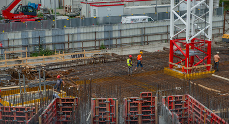 milan italy 29 june 2019: Workers at work in the construction of the bases of the base of the nest...