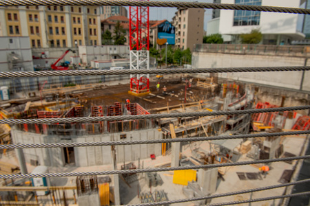 milan italy 29 june 2019: Workers at work in the construction of the bases of the base of the nest vertical a futuristic building in the business district of the island district in milanのeditorial素材