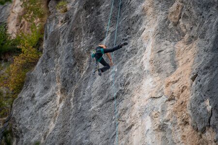 Cornalba Bergamo Italy 6 october 2019: Climbing at the Cornalba crag a rock climbing wall with very distinctive stretchesの写真素材