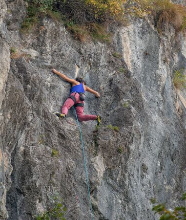 Cornalba Bergamo Italy 6 october 2019: Climbing at the Cornalba crag a rock climbing wall with very distinctive stretchesの写真素材