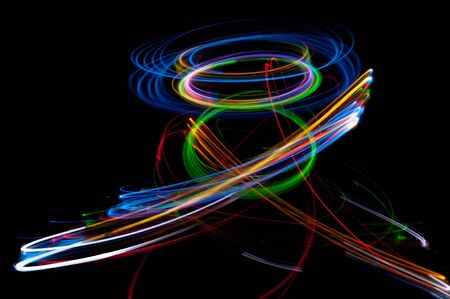 colored streaks of light in the darkの写真素材