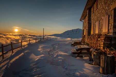 mountain refuge surrounded by snow