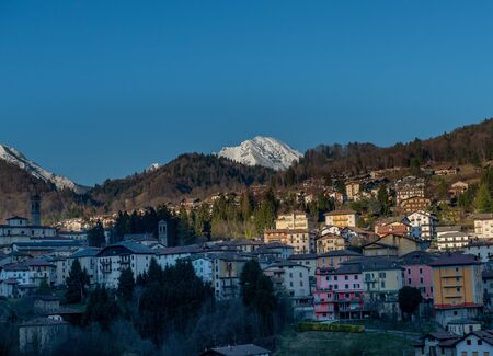 sun illuminating mountain village after snowfall