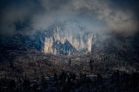 sun illuminating mountain village after snowfallの写真素材