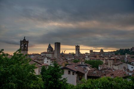 Bergamo at sunset in the old city with towers and bell tower