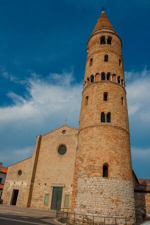 Brick bell tower of the cathedral of Caorleの写真素材