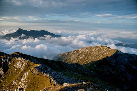 Sunrise with clouds seen from the Arera peakの写真素材