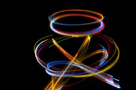 colored streaks of light in the darkの写真素材