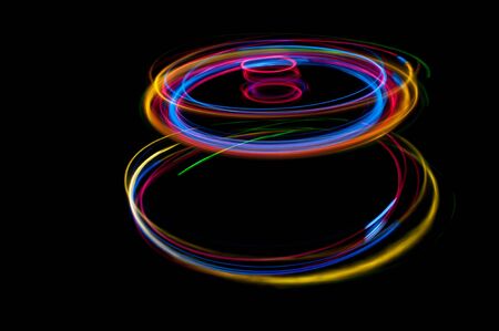 colored streaks of light in the darkの写真素材