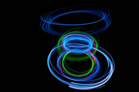 colored streaks of light in the darkの写真素材