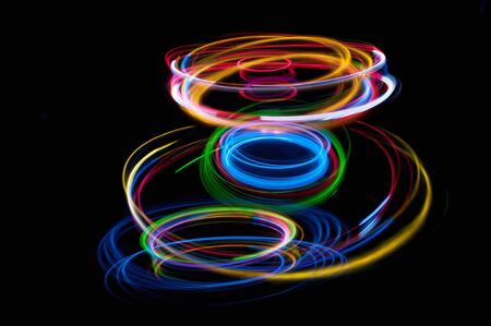 colored streaks of light in the darkの写真素材