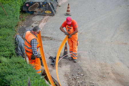 Zorzone Bergamo Italy 23 September 2020: Workers at work to bury the cables of the ultra-fast networkのeditorial素材