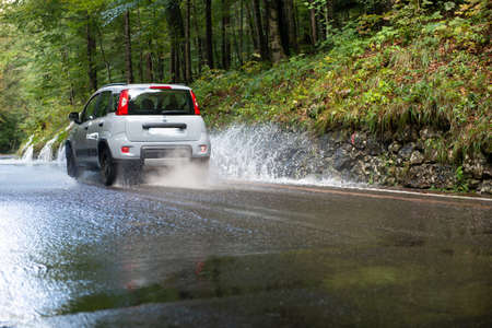 car traveling on flooded roadの写真素材