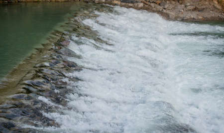 cascade of water that overflows from the damの写真素材