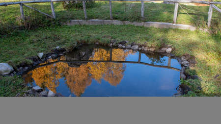 cottage with a pond where nature is reflectedの写真素材