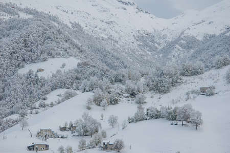 Mountains after heavy snowfall with sunbeamsの写真素材
