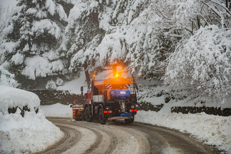 Snow clearing in the mountain roadの写真素材