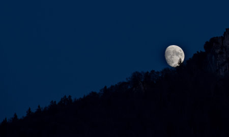 moon rising behind the mountainの写真素材