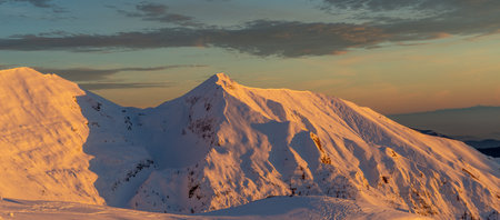 snow-covered mountain Grem at sunsetの写真素材