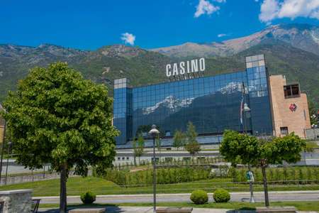 Saint-Vincent Aosta Italy June 1st 2019; Exterior stained glass window reflecting the mountains of the Casino de la VallÃ©e, also known as the Casino of Saint-Vincent, is one of the three Italian gambling houses, the only one in the Aosta Valleyのeditorial素材