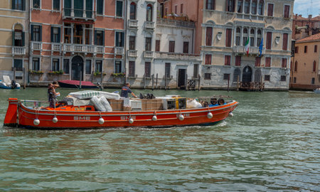 venice italy 18 july 2020: Freight transport by boat in the grand canal of veniceの写真素材