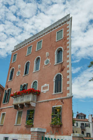 Facade of a house with a flowered balcony in Veniceのeditorial素材