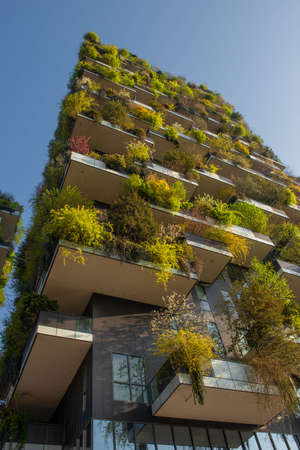 milan italy march 29 2021: Bosco Verticale "new and modern skyscraper with trees growing on the balconies, in the Isola district of Milan which is reflected in the water of the fountainのeditorial素材