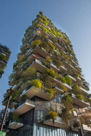 milan italy march 29 2021: Bosco Verticale "new and modern skyscraper with trees growing on the balconies, in the Isola district of Milan which is reflected in the water of the fountainのeditorial素材