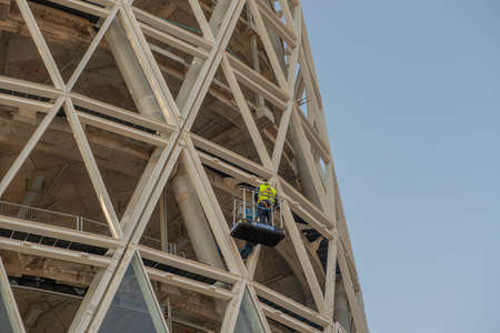 milan italy 30 march 2021: workers on a platform in mobile safety while installing the electrical...