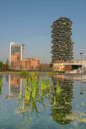 milan italy march 29 2021: Bosco Verticale "new and modern skyscraper with trees growing on the balconies, in the Isola district of Milan which is reflected in the water of the fountainのeditorial素材