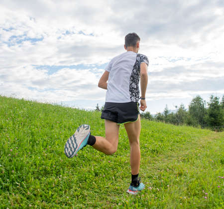 marathon runner training in the middle of the fieldsの写真素材