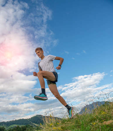 marathon runner training in the middle of the fieldsの写真素材