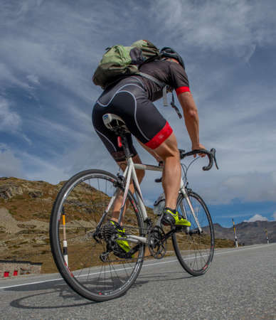 Bernina Switzerland 27 September 2021: Cyclist under stress uphill while climbing the Bernina Passの写真素材