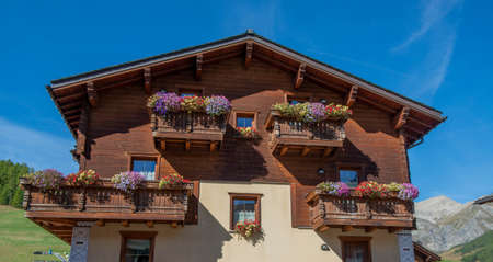 Livigno Italy 28 September 2021:Wooden house with flowers on the balconyの写真素材