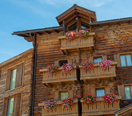 Livigno Italy 28 September 2021:Wooden house with flowers on the balconyの写真素材