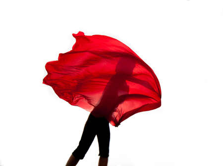 girl flies red scarf in the airの写真素材