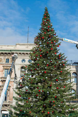 Milan Italy 1 December 2021:workers on the platform while decorating the Christmas tree in Piazza Duomo in Milanの写真素材