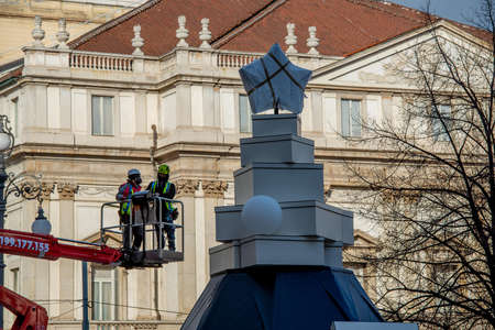 Milan Italy 1 December 2021:workers on the platform while decorating the Christmas tree in Piazza scala in Milanの写真素材